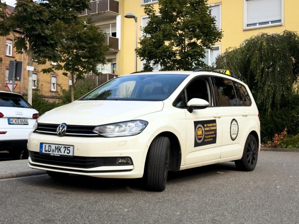 white Mk taxi in landau