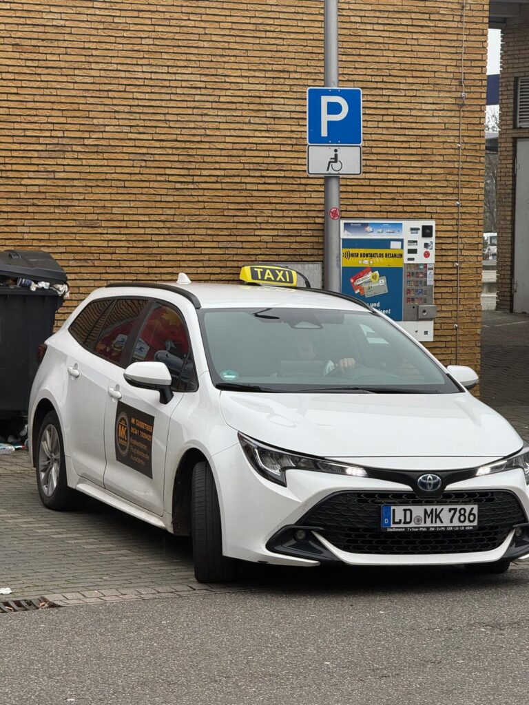 white MK landau laxi parked on roadside