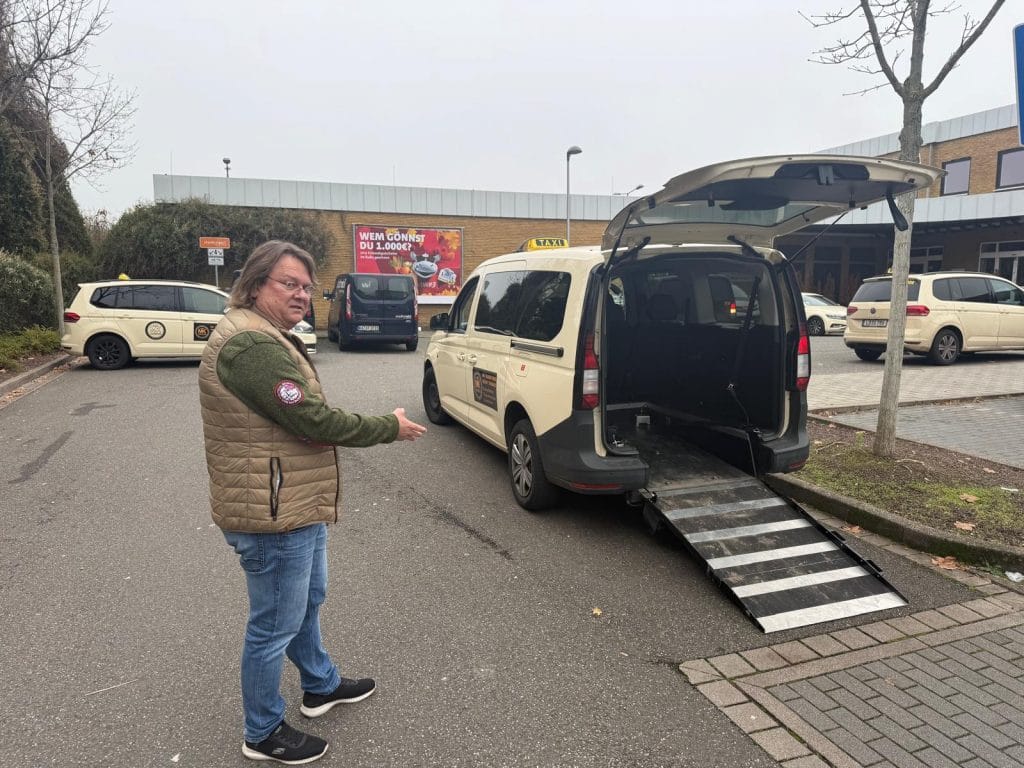Driver with MK taxi Landau wheelchair taxi